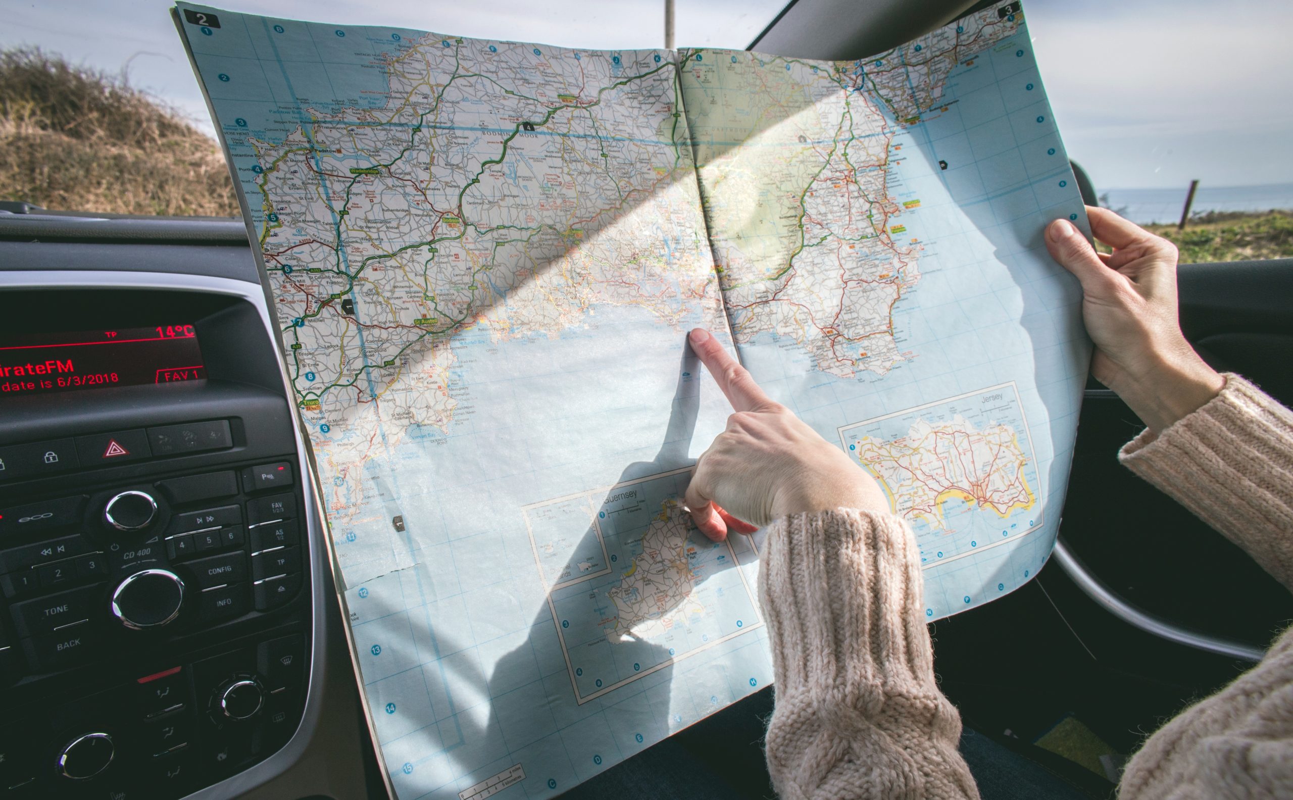 woman in car navigating on map