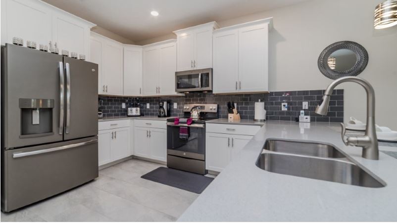 A spacious kitchen in the theme grayscale featured by a luxury vacation rental in Orlando, Florida