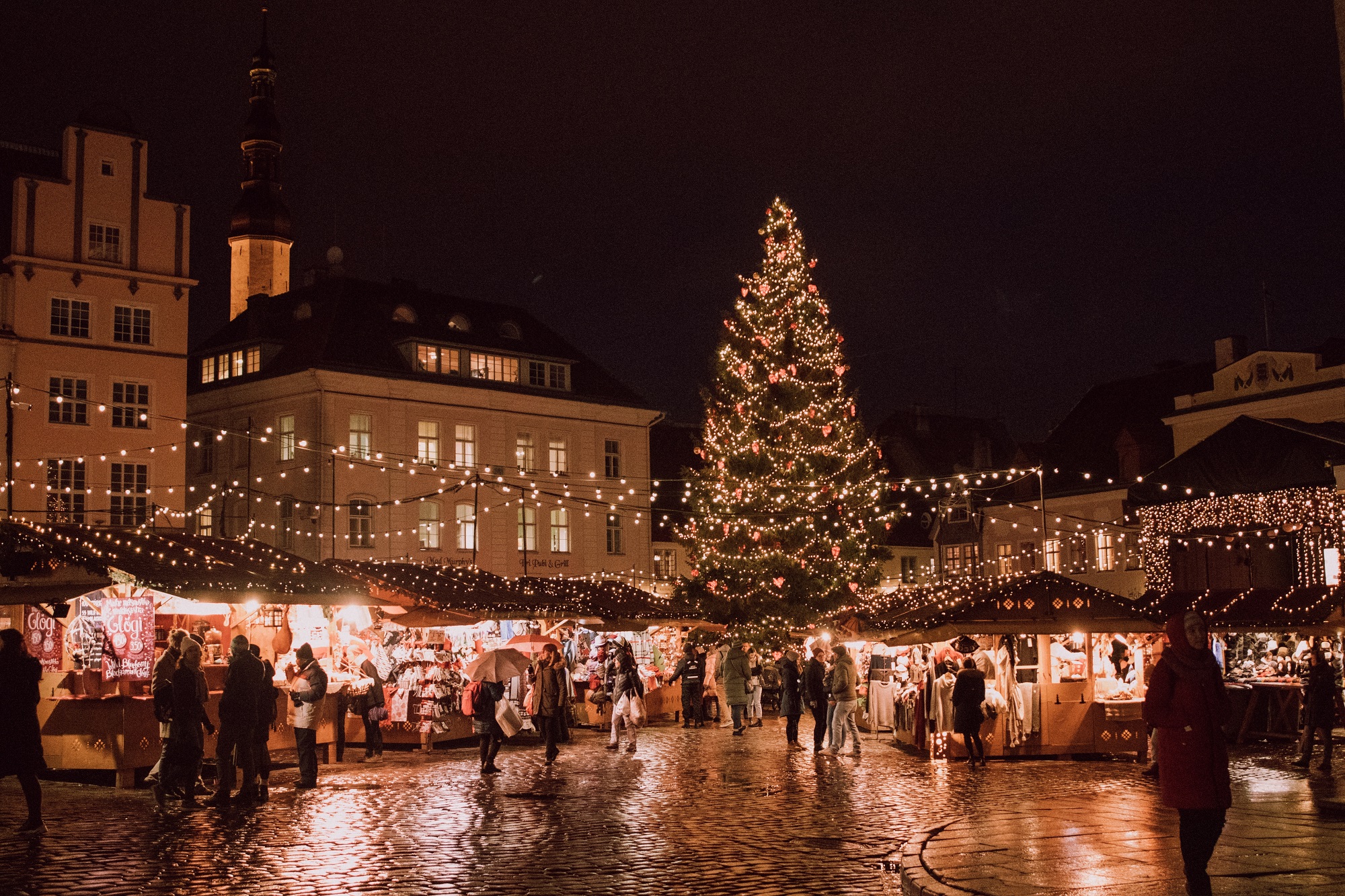 Busy marketplace with a large Christmas tree