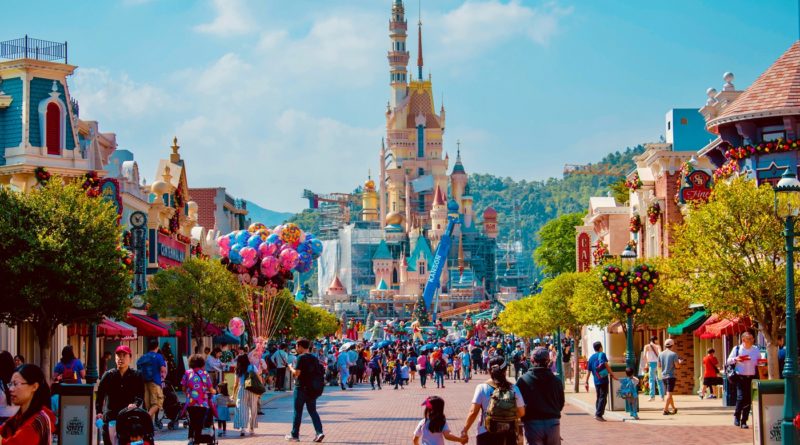 tourists visit the Disney castle at Disney World