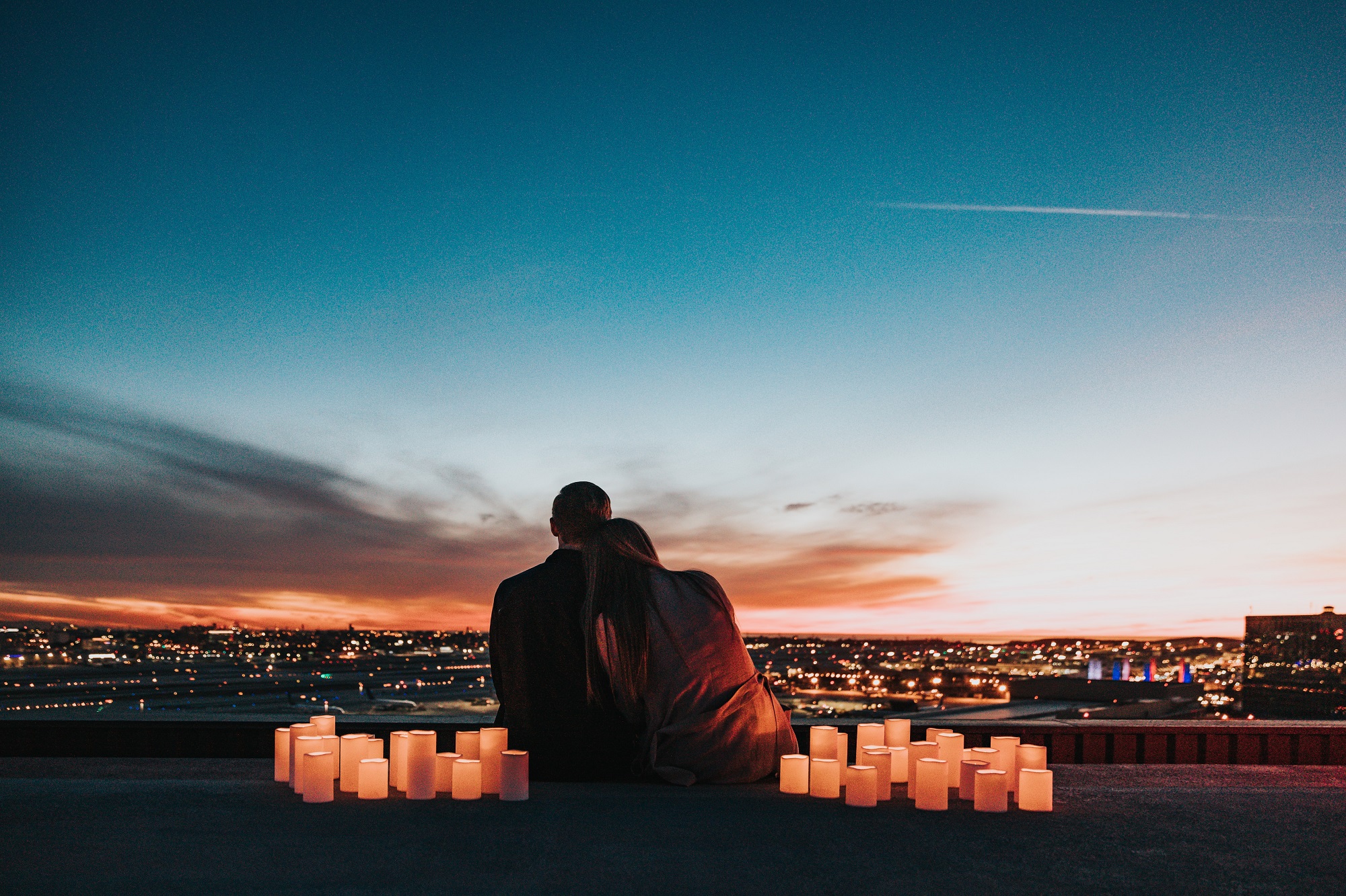 couple sitting on the sidewalk