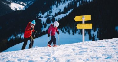 an image showing a kid going for a skiing adventure with his father