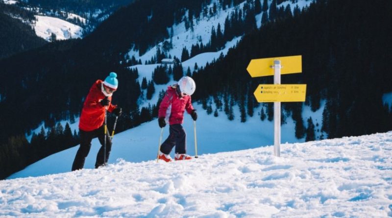 an image showing a kid going for a skiing adventure with his father