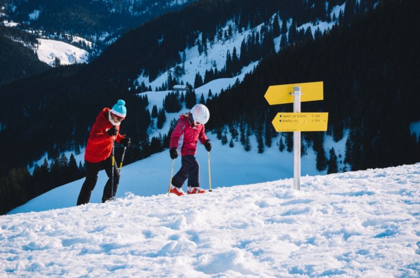 an image showing a kid going for a skiing adventure with his father