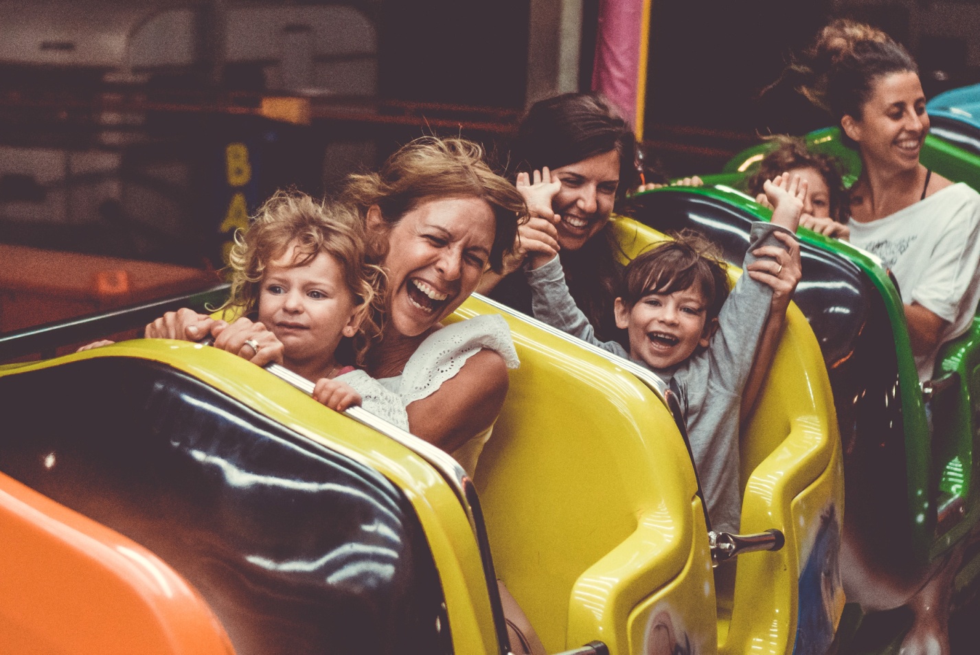 Kids with their families having fun on a rollercoaster