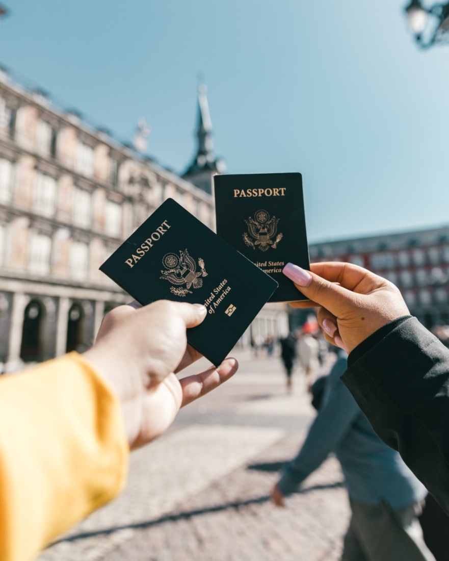 Tourists holding up passports out on the street