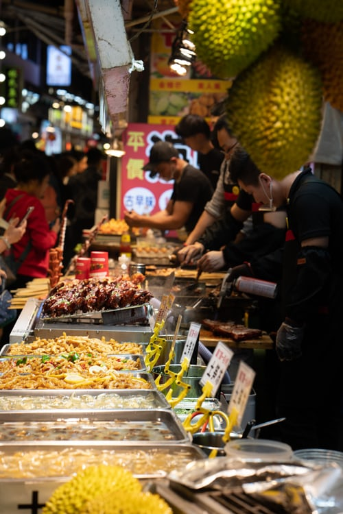 multiple food stalls on a local food street.