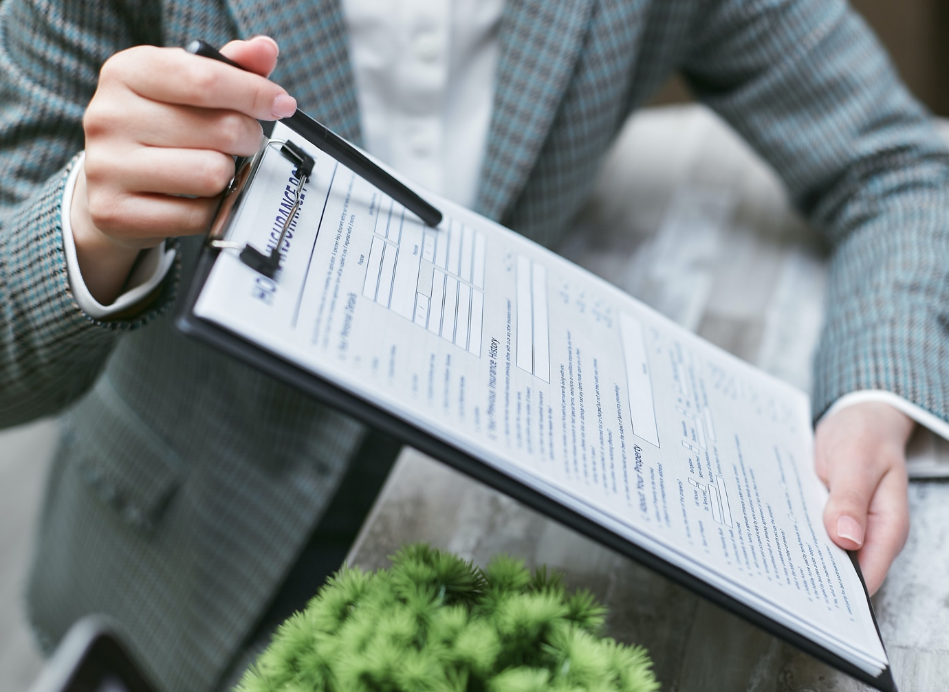 a person holding an insurance contract paper